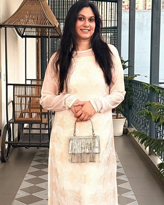 Chandni Noor ivory kurta set worn with silver clutch