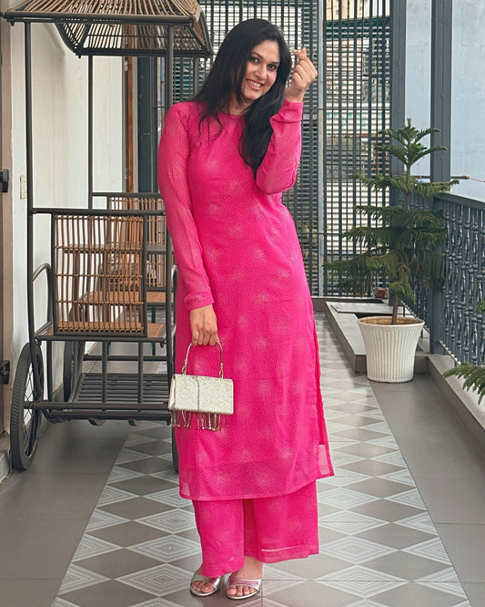 Chandni Noor rani pink kurta set worn with silver clutch
